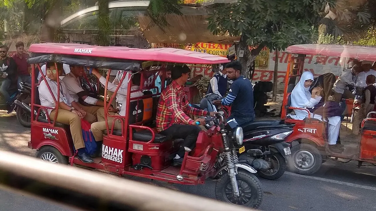 Electric rickshaws carrying passengers in traffic in Aligarh, Uttar Pradesh