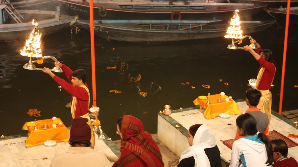 Priests performing the evening Ganga aarti with lamps in Varanasi